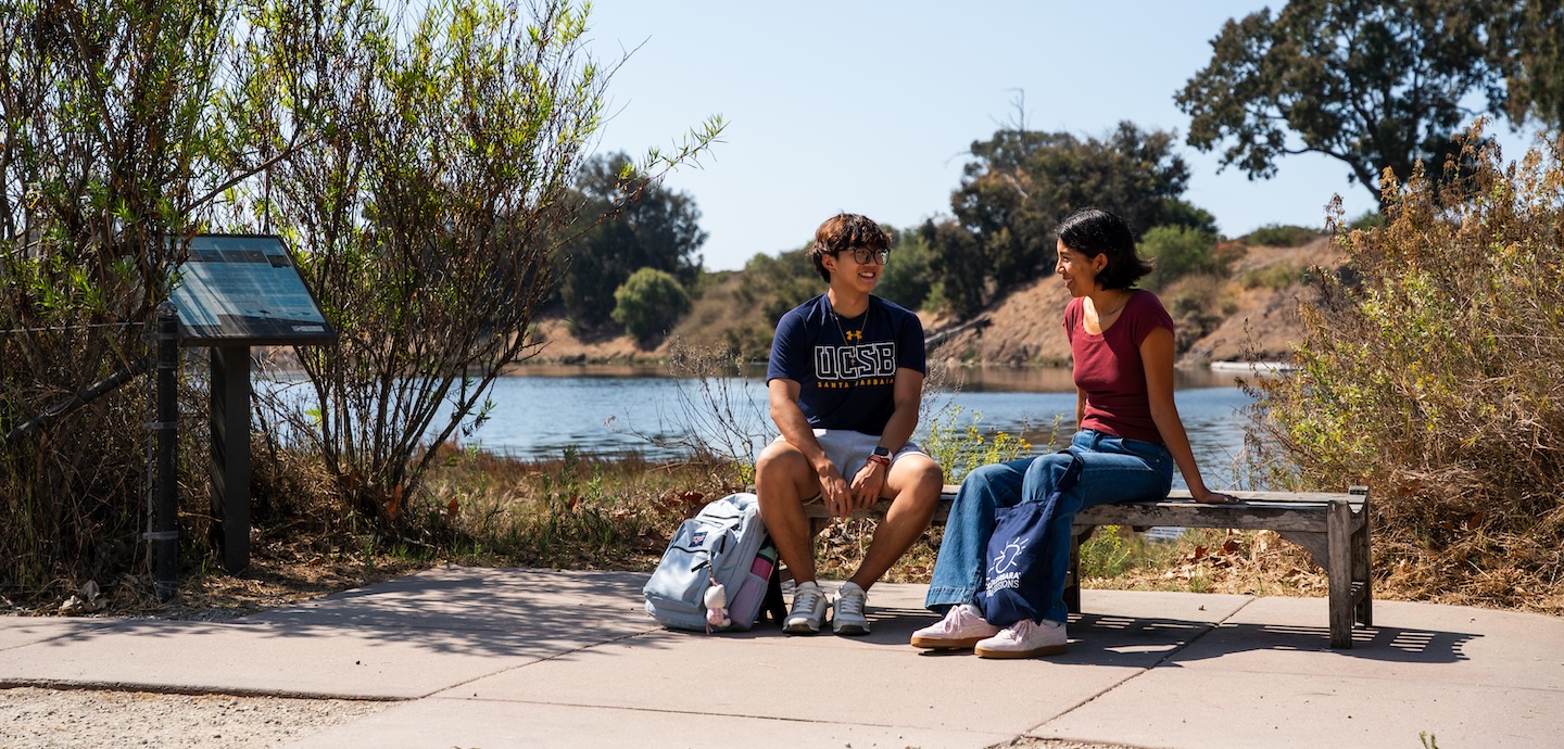 Students sitting by lagoon
