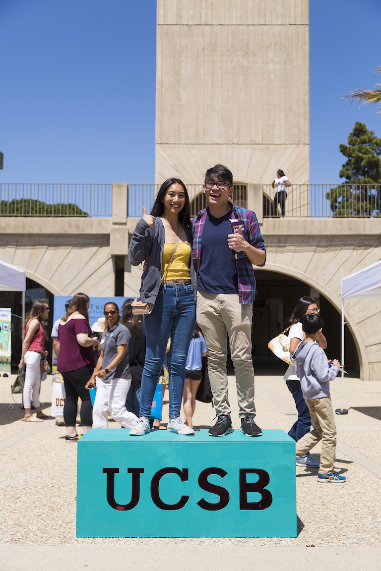 students on ucsb block with thumbs up